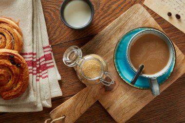 Coffee late, brown sugar, milk and croissants, from above