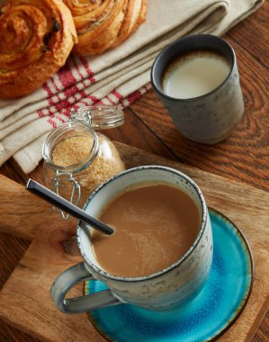 Coffee with milk, brown sugar and croissants