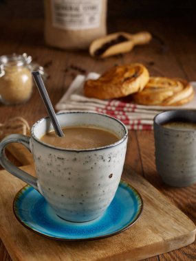Coffee with milk, brown sugar and croissants