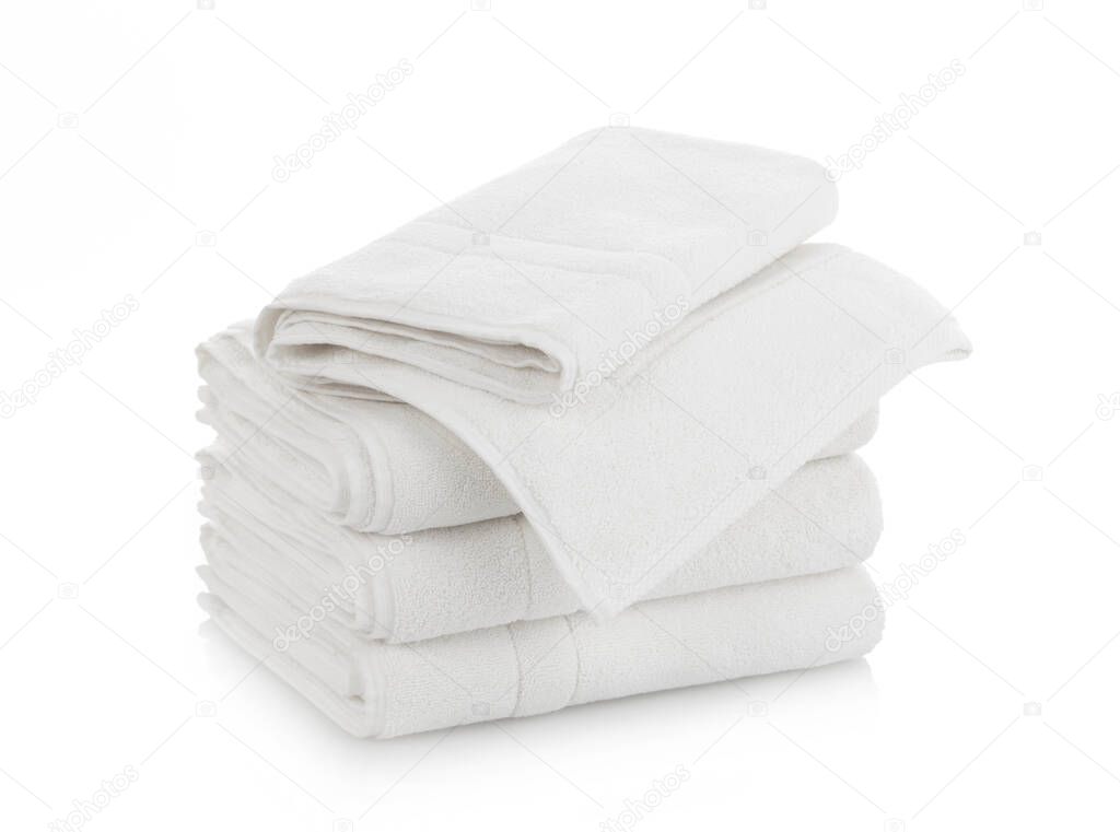 Stack of folded white cotton towels on white background