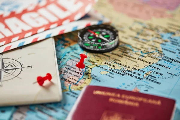 Maps, pins, compass and passport