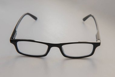 Black glasses on gray background