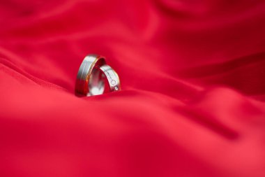 Wedding rings on a red satin background