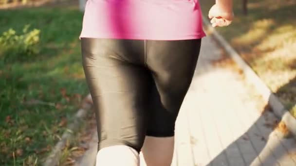 Fat ass of a woman running in the park — Video Stock