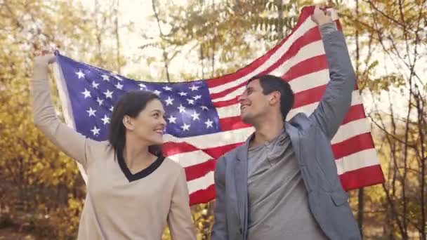 Casal jovem com bandeira dos EUA — Vídeo de Stock