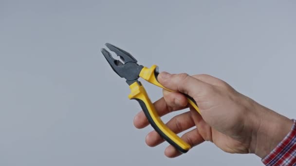 Hand holding pliers on white background — Stock Video