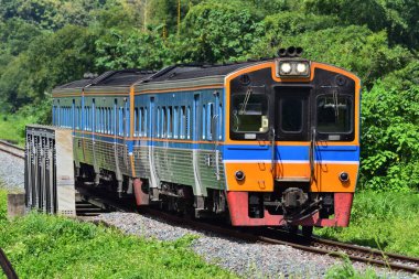 Diesel railcar passes the bridge