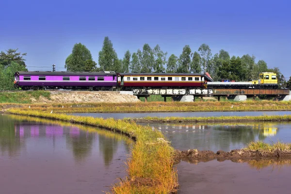 Railway track maintenance machine with passenger coaches.