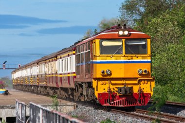 Passenger train by diesel locomotive on the railway.