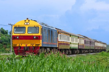 Passenger train by diesel locomotive on the railway.