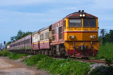 Passenger train by diesel locomotive on the railway.