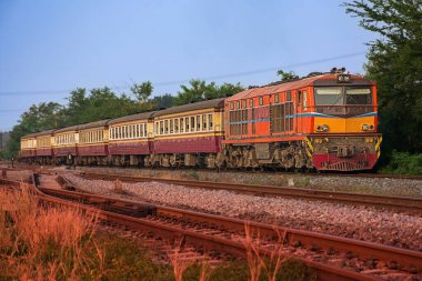 Passenger train by diesel locomotive on the railway 