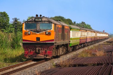 Passenger train by diesel locomotive on the railway.