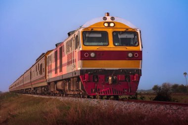 Passenger train by diesel locomotive on the railway.