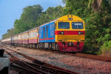 Passenger train by diesel locomotive on the railway.