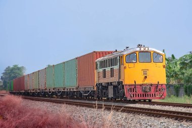 Container-freight train by diesel locomotive on the railway.