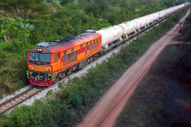Tanker-freight train by diesel locomotive on the railway.