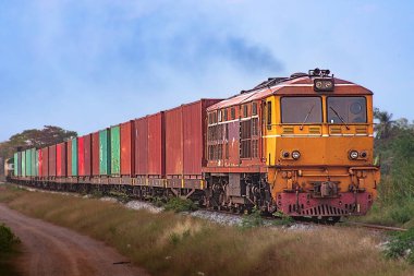 Container-freight train by diesel locomotive on the railway.
