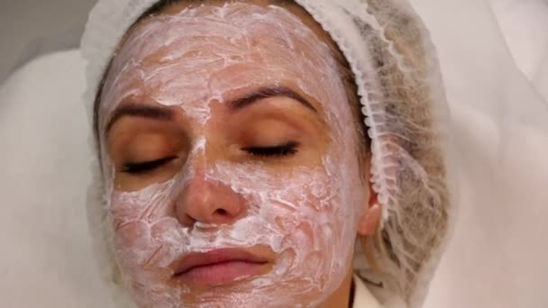 Creme anti-séptico no rosto das meninas para tratamento adicional em um salão de beleza cosmética — Vídeo de Stock