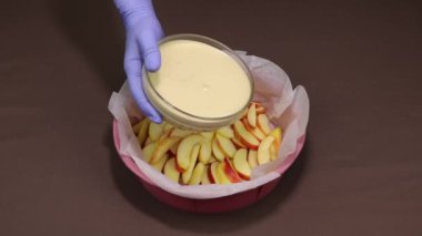 Poured dough mixture for making apple pie.