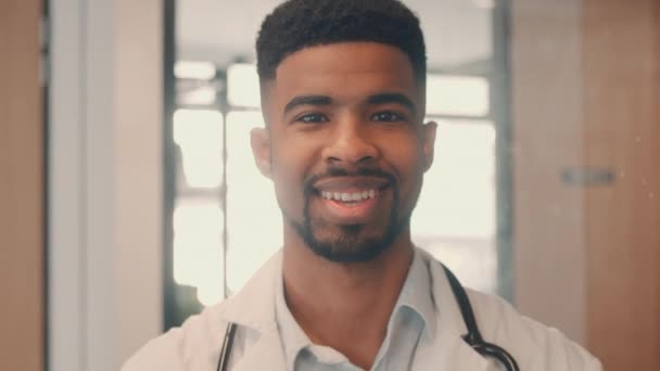 Médico masculino sonriendo mientras mira a la cámara — Vídeos de Stock