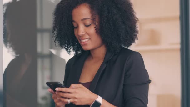 4k video footage of a business woman using a cellphone in an office — Stock video