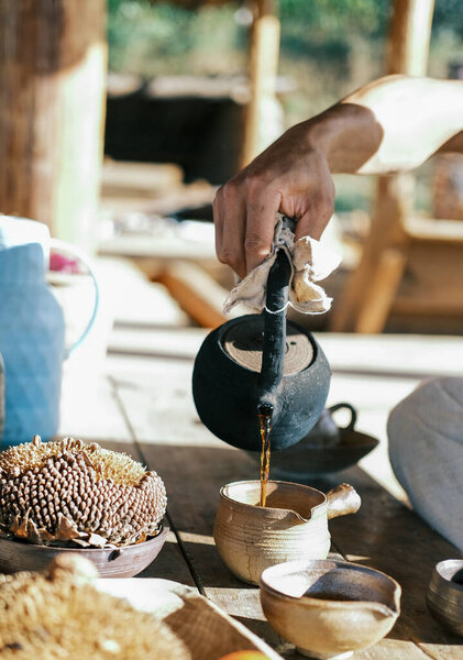 Pour tea with a teapot in hand