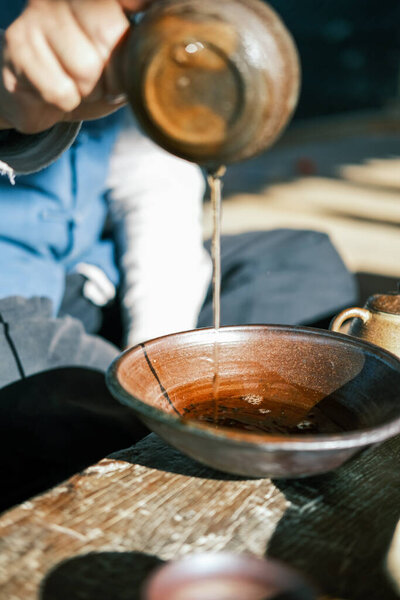 Pour tea with a teapot in hand