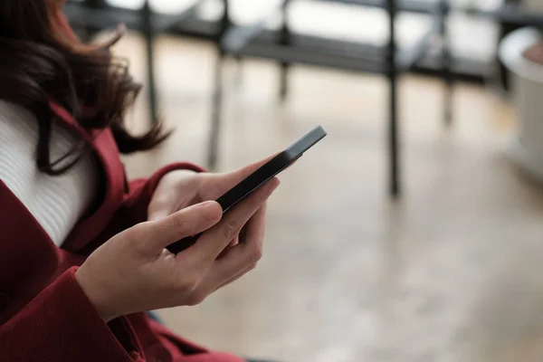 Fechar as mãos das mulheres usar um smartphone para compras on-line, redes sociais ou trabalho remoto — Fotografia de Stock