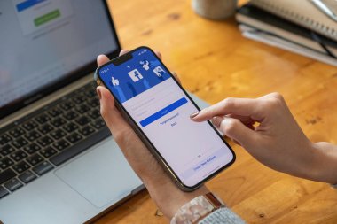 CHIANG MAI, THAILAND - OCT 17, 2021: Facebook sosyal medya uygulaması logosu, mobil uygulama ekranında kayıt sayfası iPhone 13 Pro Max 'te e-ticaret alışverişi yapan kişiler el yazısı.