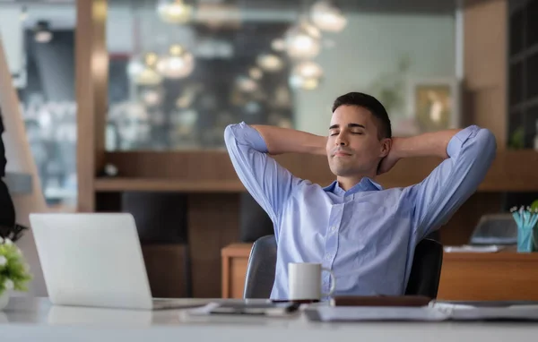 stock image Relaxed calm caucasian businessman resting sit at office desk after working for financial with laptop computer.