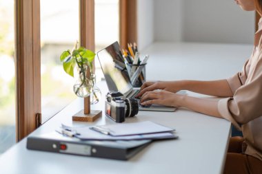 Young freelance woman hands typing on keyboard on laptop computer to work at modern office