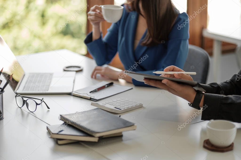 Asian business adviser meeting to analyze and discuss the situation on the financial report in the meeting room.Investment Consultant,Financial Consultant,Financial advisor and accounting concep