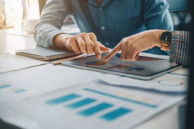 Dijital tablet ve yönetimle çalışan bir grup bilişim danışmanı büyük veriler elde ediyor ve şirketin mali belgelerini analiz ediyor