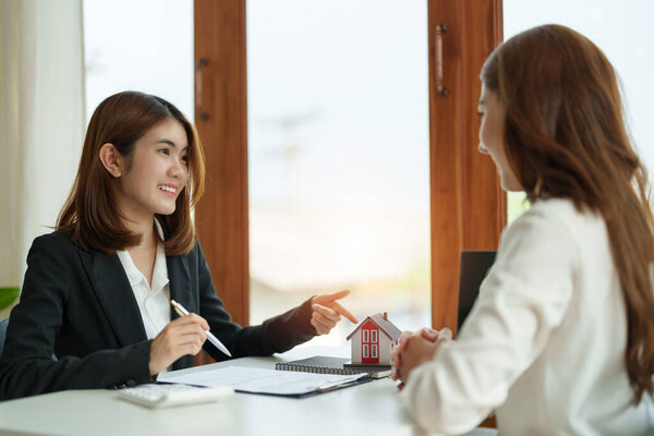 Real estate agent or bank officer describes the loan interest to the customer with home purchase contracts or on office loans and interest rates.