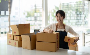 Genç Asyalı küçük işletme sahibi evde çalışma office, satınalma siparişlerinde not alma. Online Pazarlama ambalaj teslimat, başlangıç KOBİ girişimci veya serbest kadın kavramı