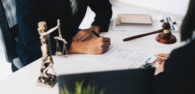 Avukat ya da yargıç yasal tavsiyelerde bulunuyor. Bir hukuk firmasında sözleşme imzalamadan önce iş adamlarına danışma şartlarını ve şartları açıklamak.