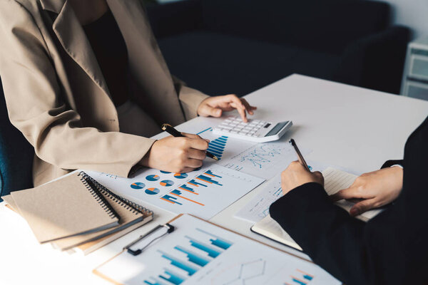 Business People Meeting to analyse and discuss and brainstorming the financial report chart data in office Financial advisor teamwork and accounting concept.