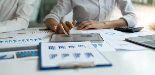 Business colleagues working and analyzing financial figures on a digital tablet — Stock Photo, Image