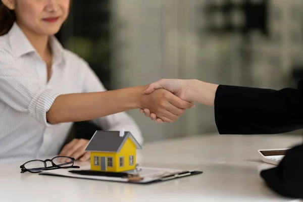 Corretor imobiliário e cliente apertando as mãos após a assinatura de um contrato: imobiliário, empréstimo de casa e conceito de seguro — Fotografia de Stock