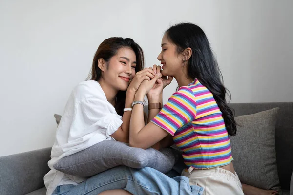 Happy lesbian, pleasure asian young two women, girl gay or close friend, couple love moment spending good time together on sofa at home. Activity of leisure, relax. — Stock Photo, Image