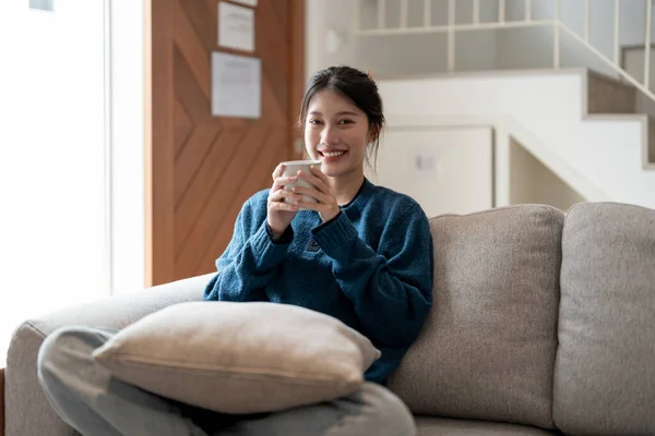 Glücklich Junge Asiatische Frau Sitzt Auf Einer Couch Mit Einer — Stockfoto