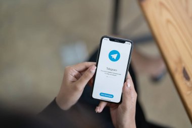 CHIANG MAI, THAILAND, HAZİRAN 31 HAZİRAN 2022: Ekranda sosyal ağ servisi telgrafıyla iPhone X 'i tutan kadın. iPhone 10 Apple Inc. tarafından oluşturuldu ve geliştirildi