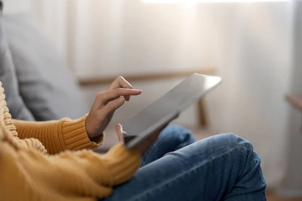 Woman pointing on digital tablet screen, chatting in social networks, meeting website, searching internet, sending sms, using text messenger or online banking. Close up photo