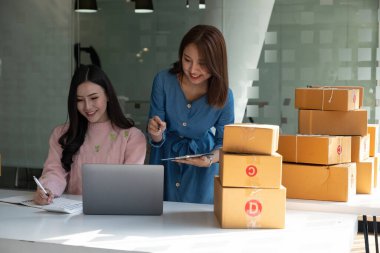 İş arkadaşları internetten alışveriş yapıyor. Ev ofisinde dizüstü bilgisayar ve kutu ile çalışıyorlar. Depoda çalışan genç kızlar var. Laptop bilgisayarında tartışan iki meslektaş.