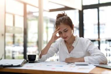 Young asian Woman Office Worker Uses Laptop, Feels Sudden Burst of Pain, Headache, Migraine. Overworked Accountant Feeling Project Pressure, Stress, Massages Her Head, Temples