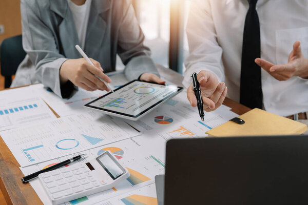 Asian business adviser meeting to analyze and discuss the situation on the financial report in the meeting room.Investment Consultant, Financial advisor and accounting concept.