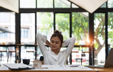 Smiling mixed-race student relaxing after working on laptop