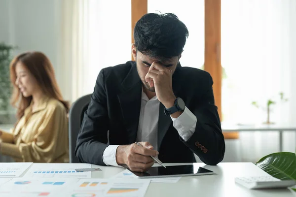 Businessman struggling with occupational stress, trying to find a solution to his problem.
