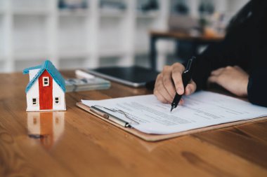Real estate agent working sign agreement document contract for home loan insurance